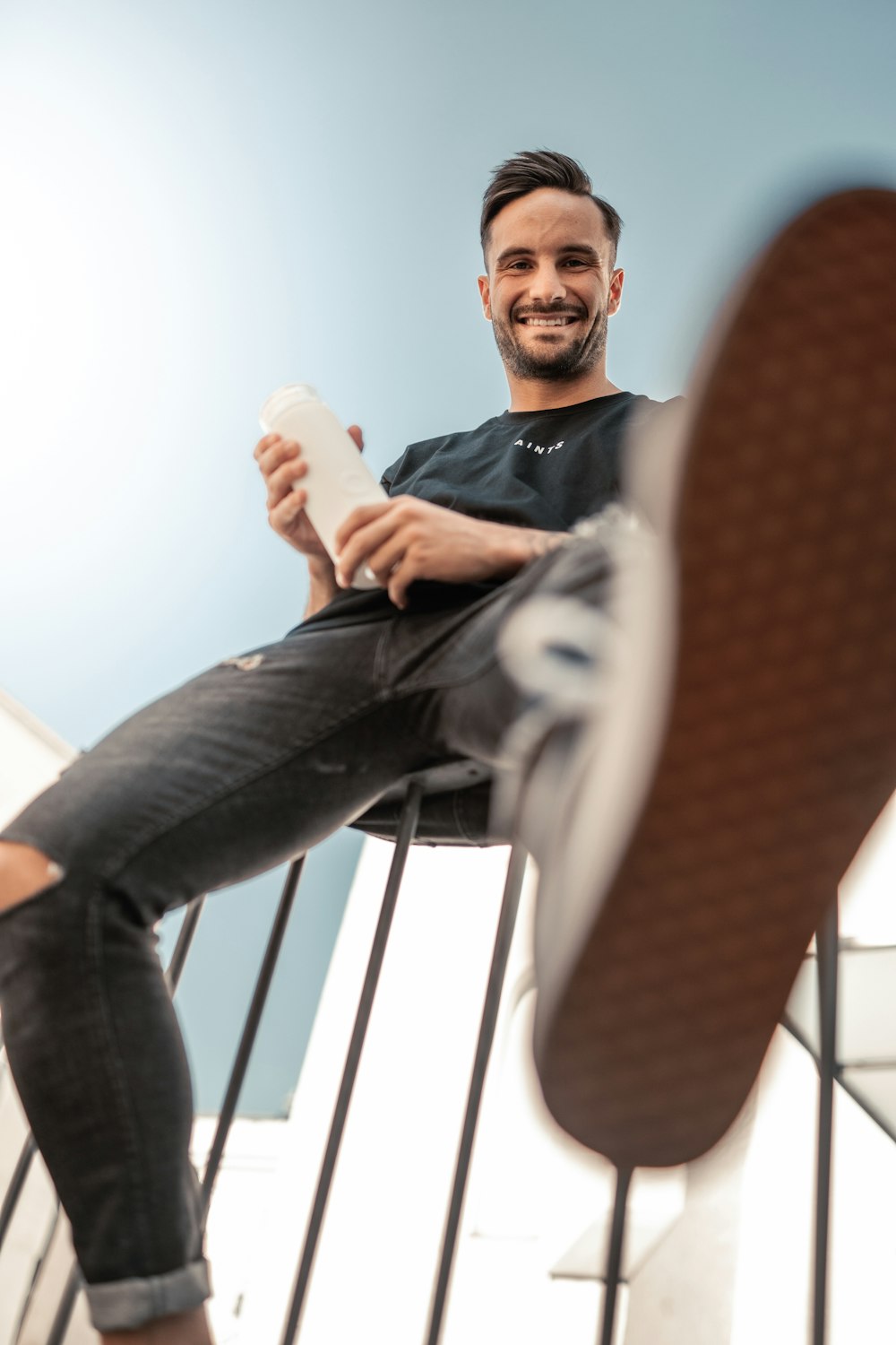 a man sitting in a chair holding a piece of paper