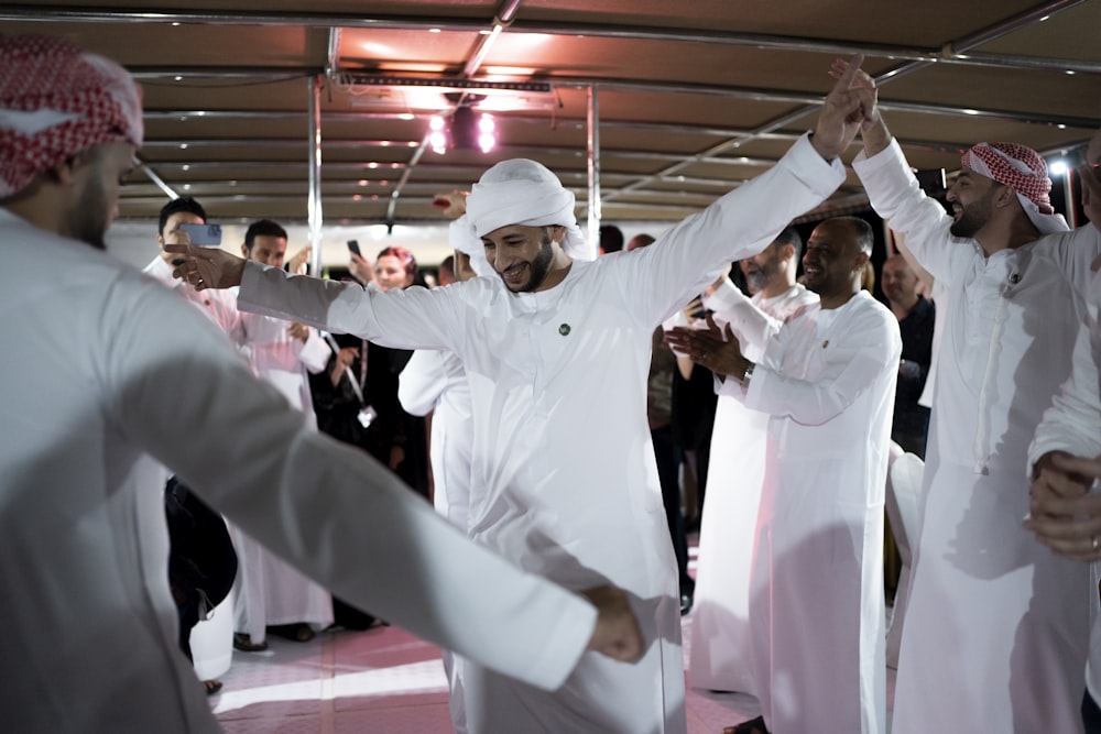 a group of men standing next to each other on a dance floor