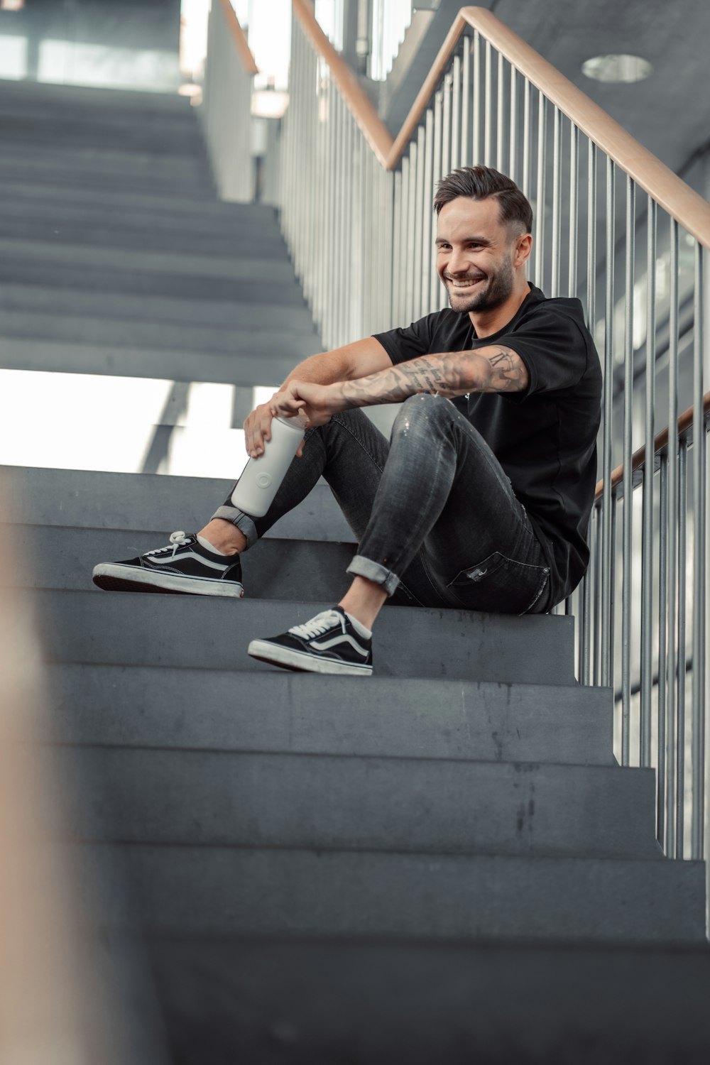 a man sitting on the steps of a stair case