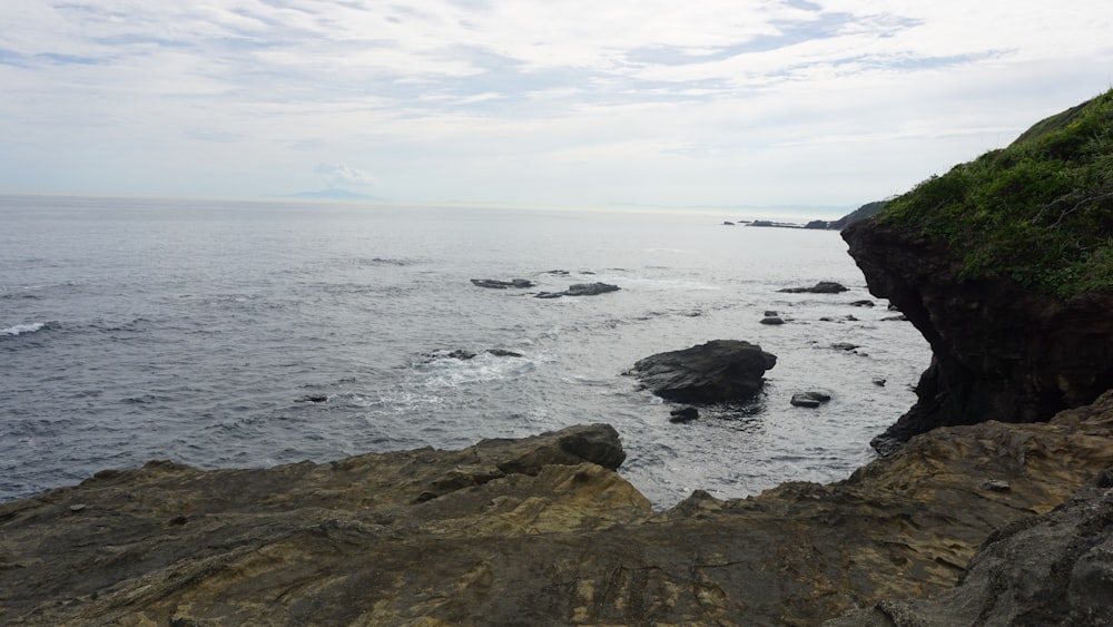 a view of the ocean from a rocky cliff