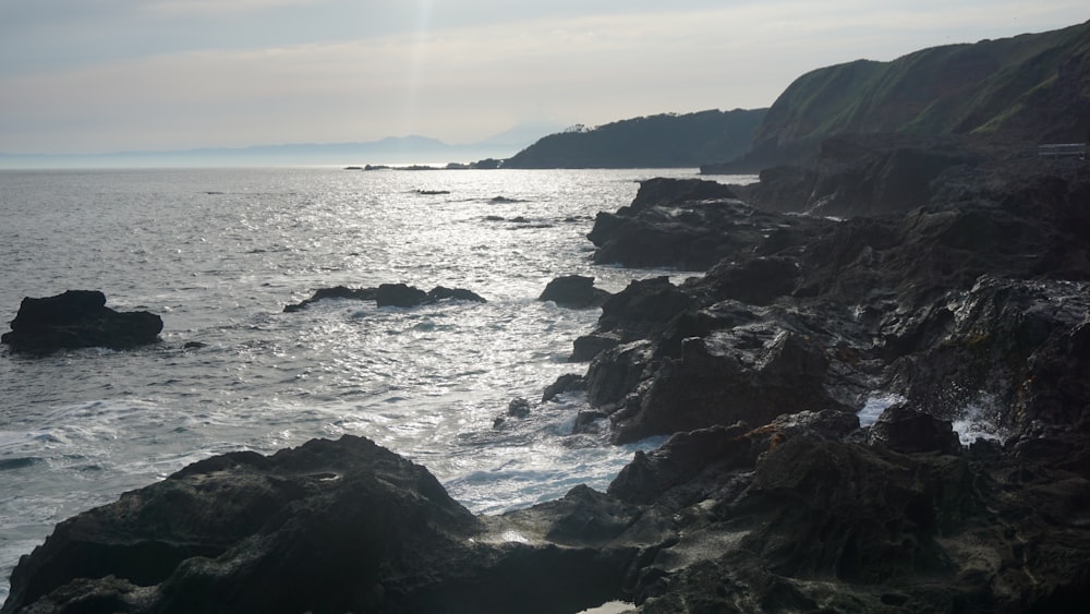 a body of water near a rocky shore