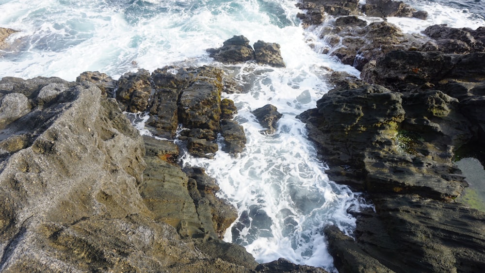 a view of the ocean from a rocky cliff