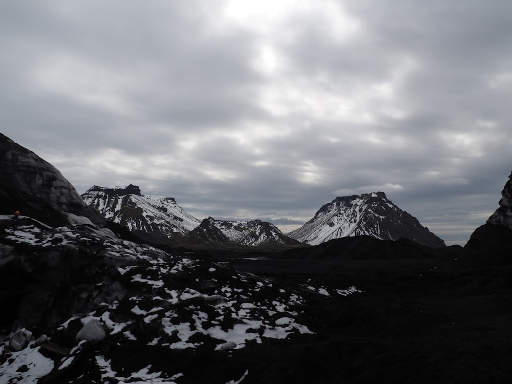 a mountain range with snow on the ground