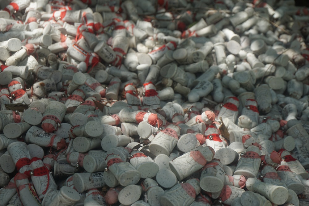 a large pile of white and red bottles