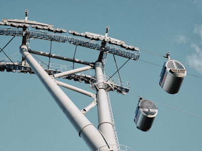 A garage door off its track with cables visible, ready for repair.