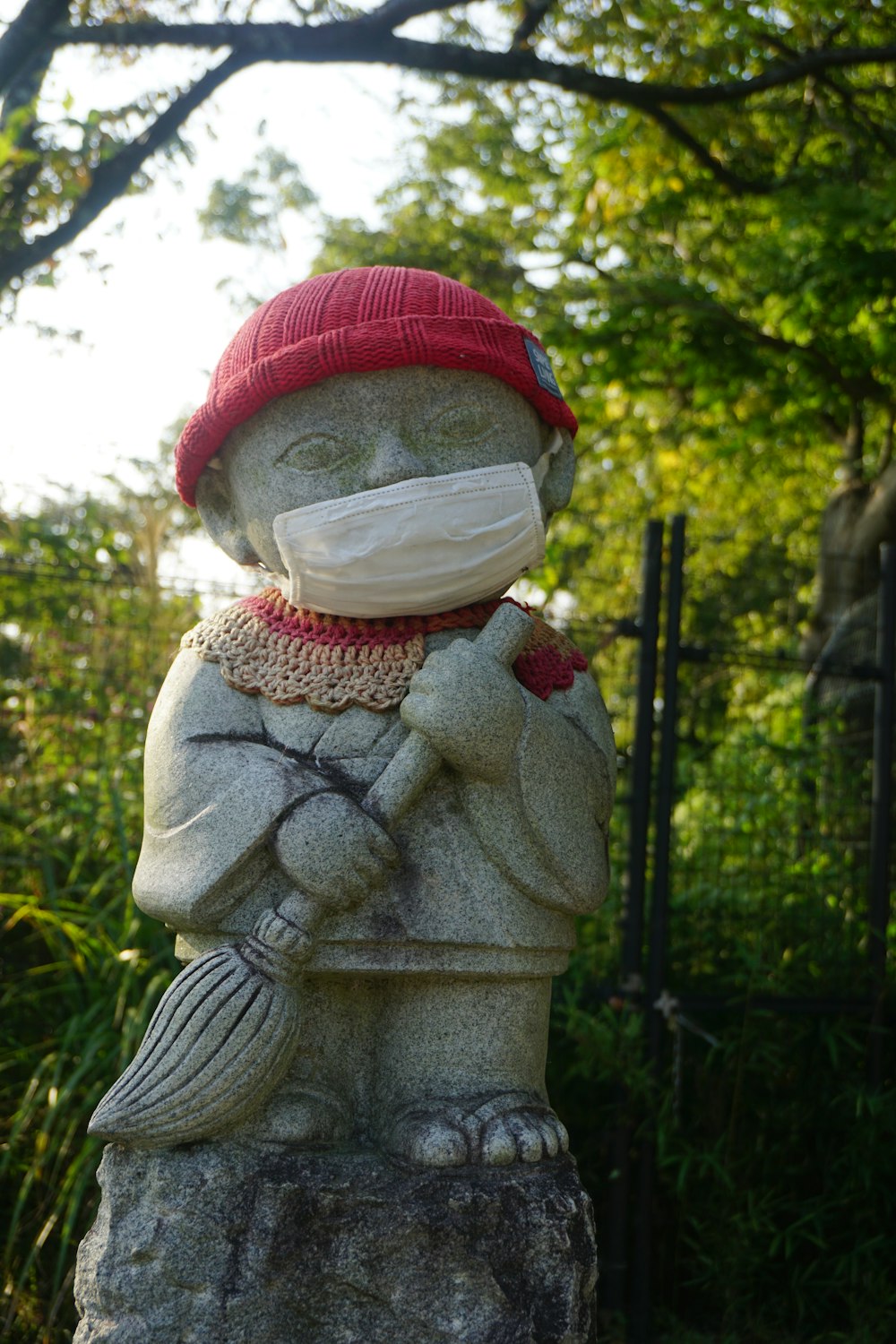 a statue of a person wearing a face mask