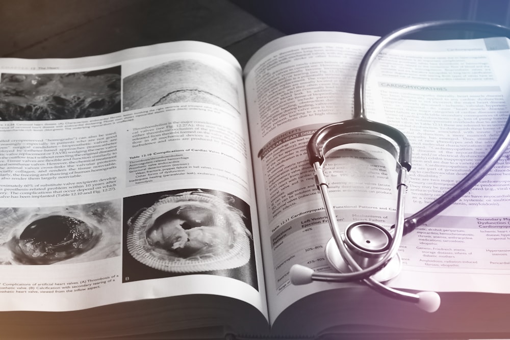 an open book with a stethoscope on top of it