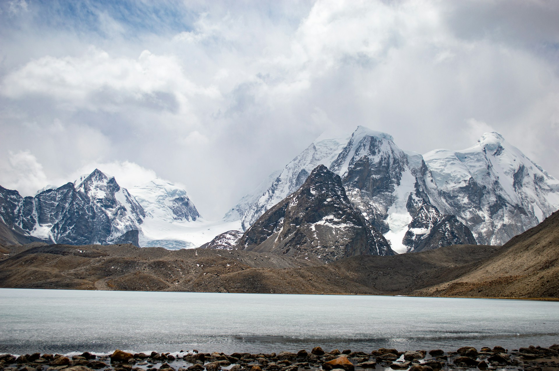 a mountain range with a lake in the foreground