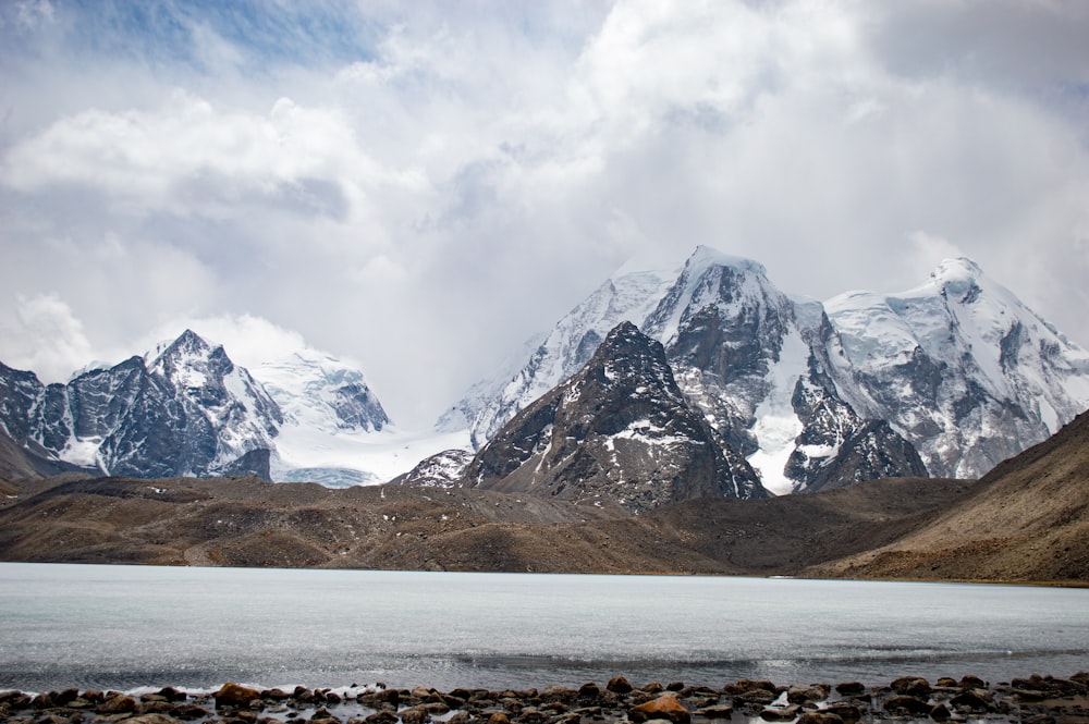 a mountain range with a lake in the foreground