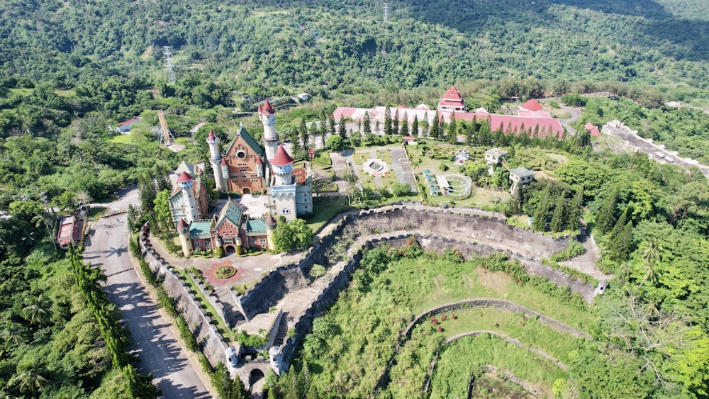 an aerial view of a castle in the middle of a forest