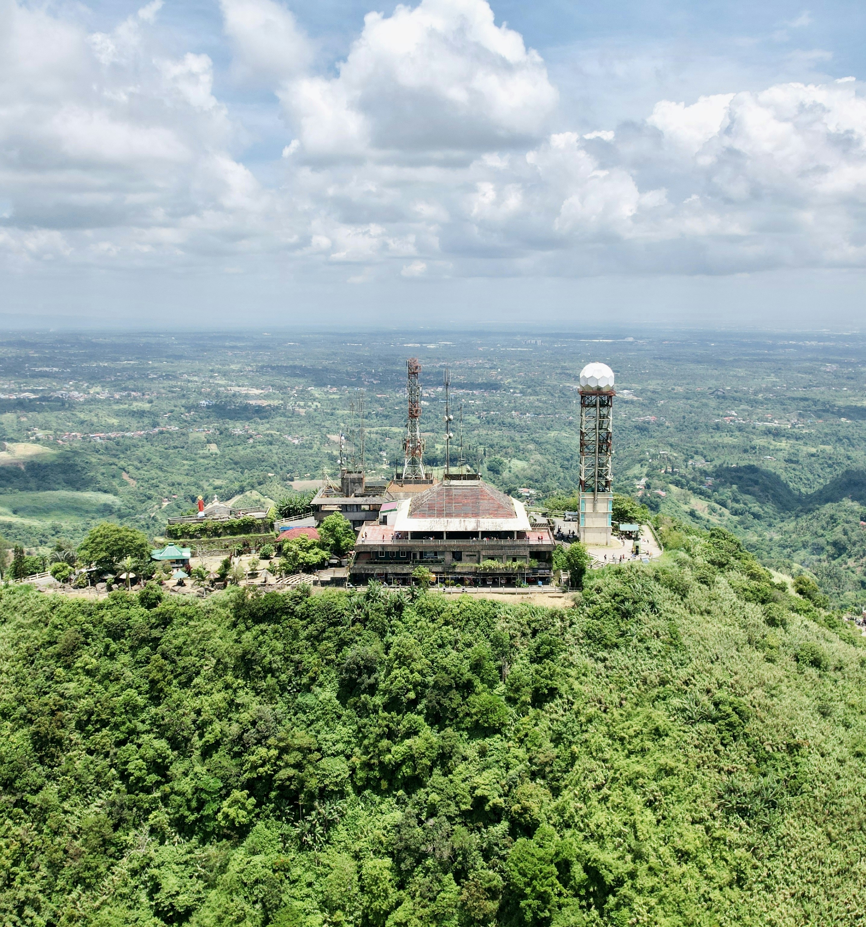 a large building on top of a lush green hillside