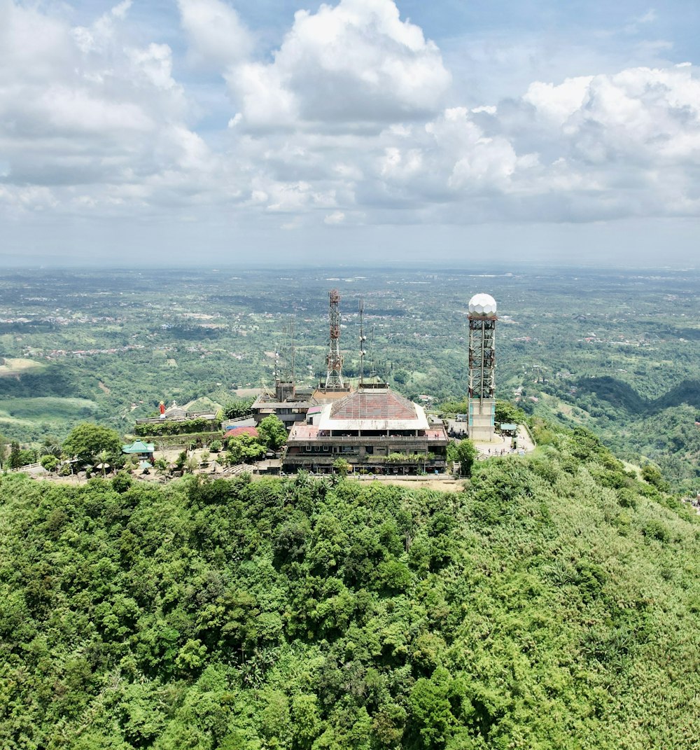 a large building on top of a lush green hillside