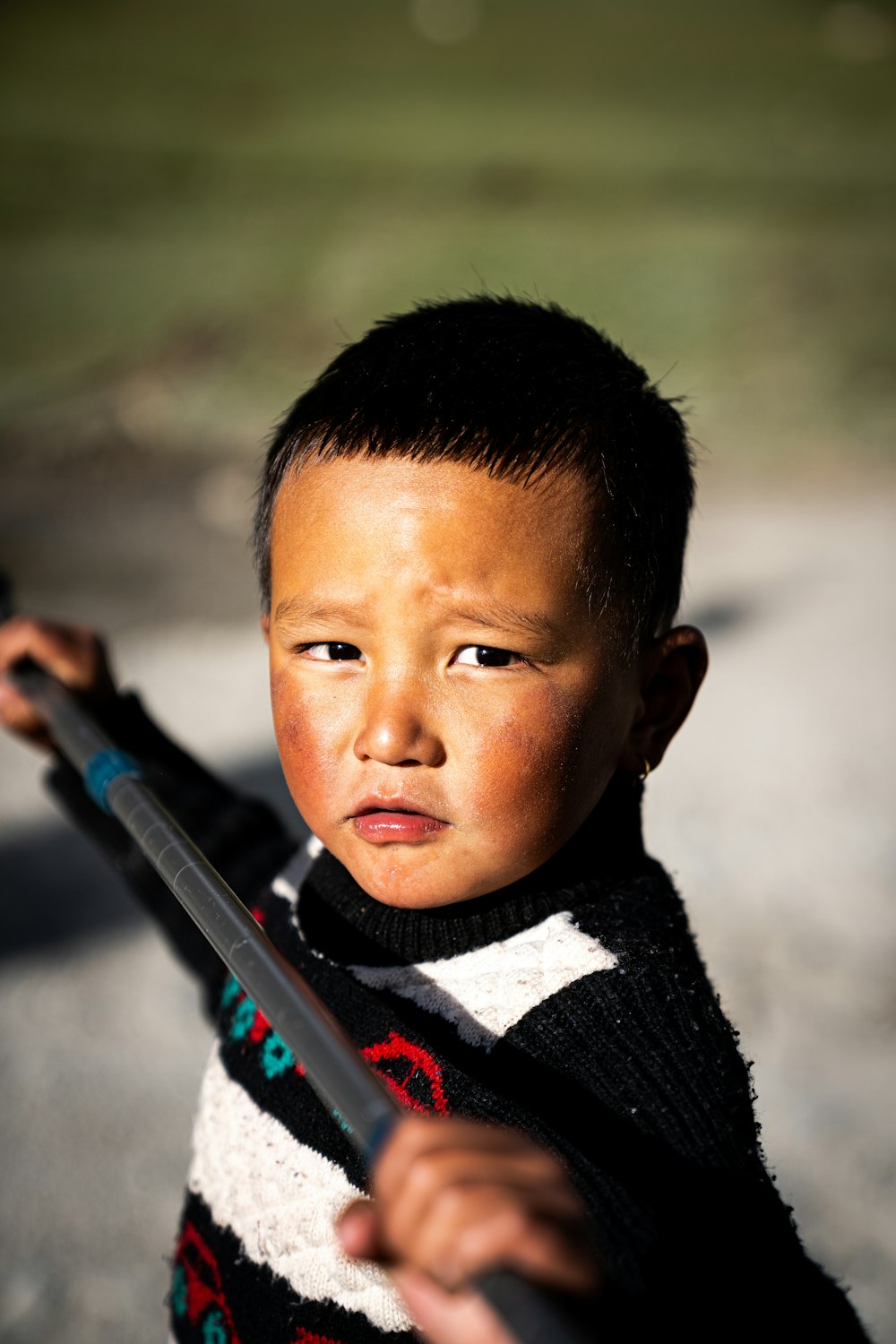 a young boy is holding a baseball bat