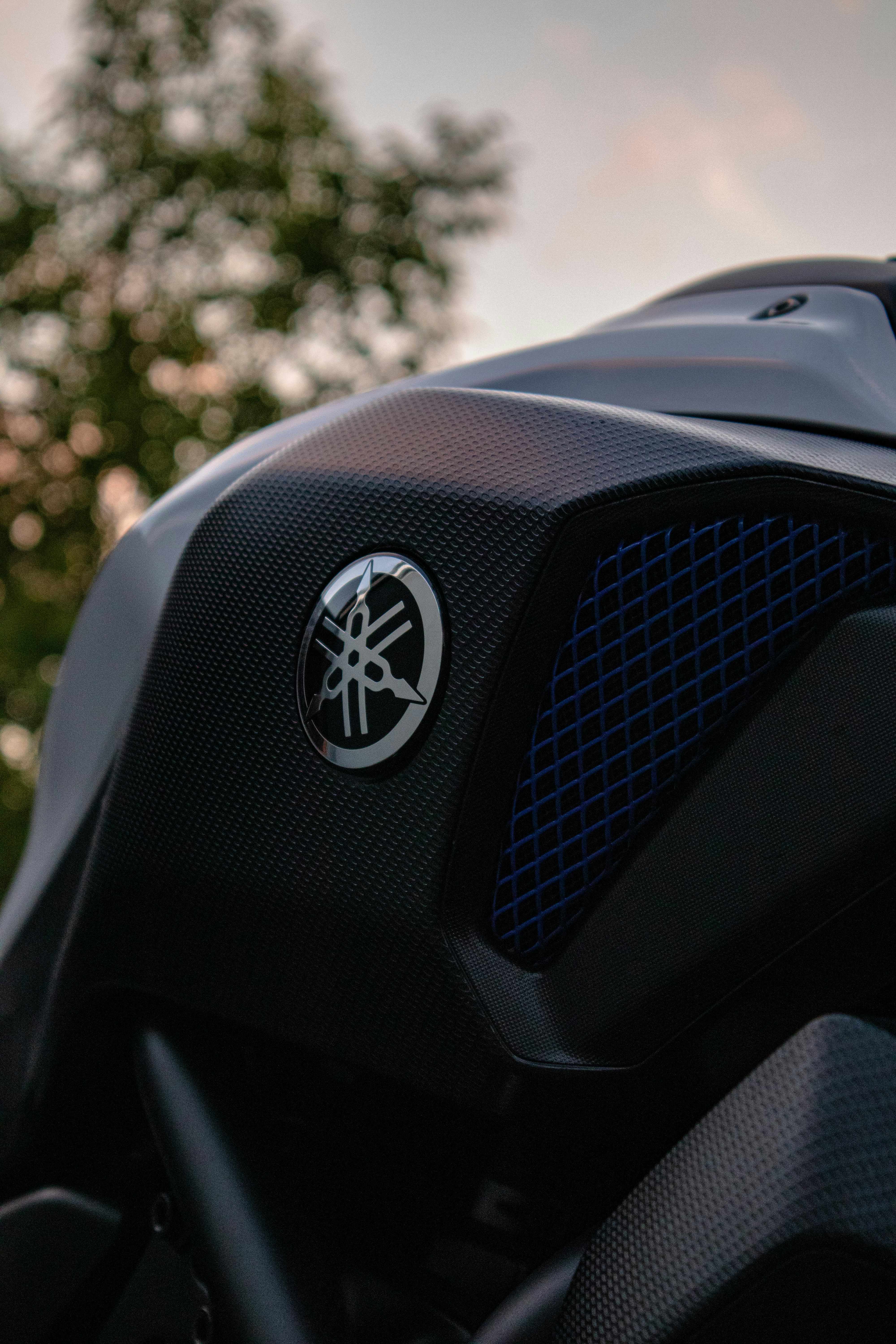 a close up of a motorcycle with trees in the background
