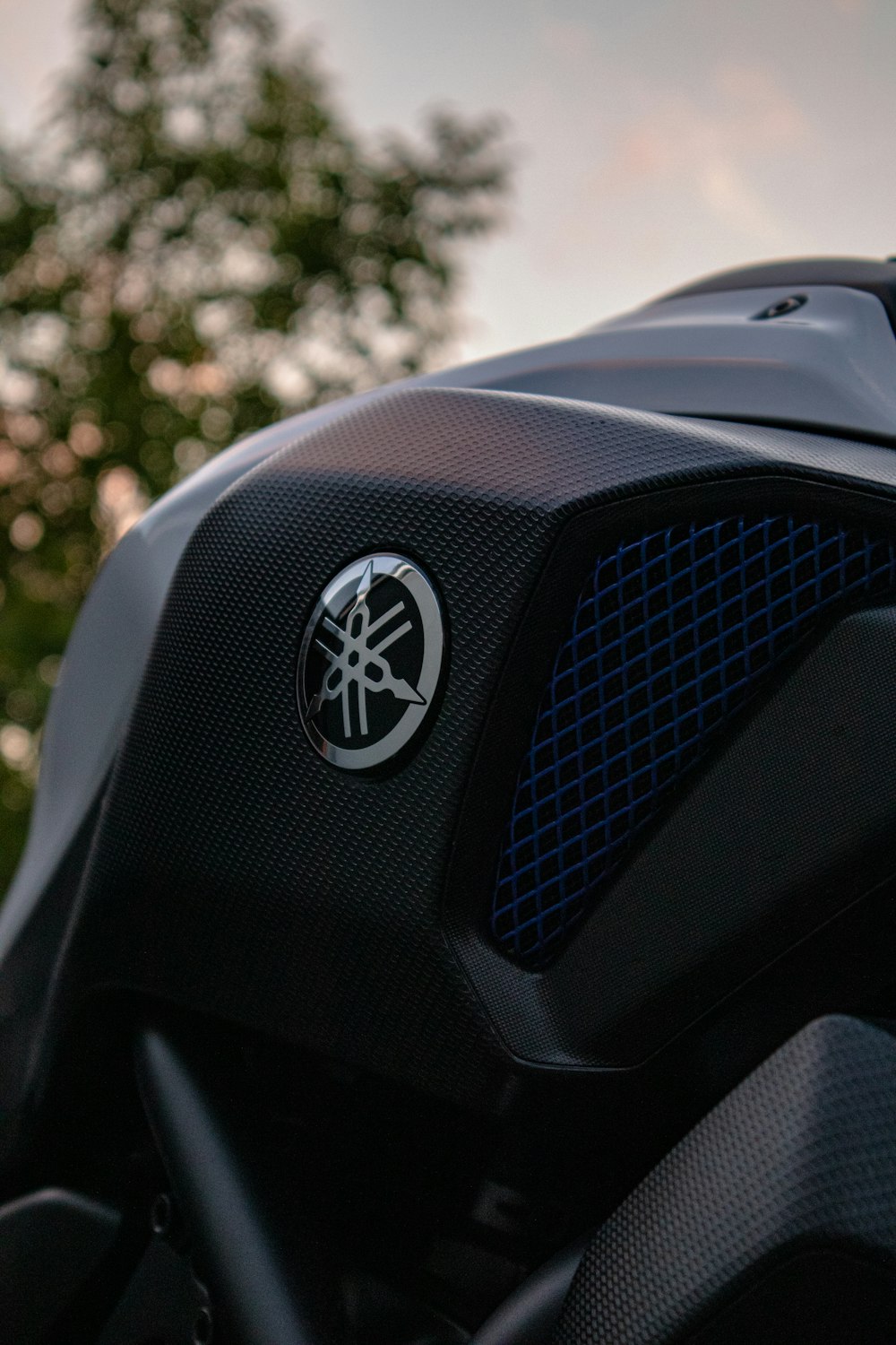 a close up of a motorcycle with trees in the background