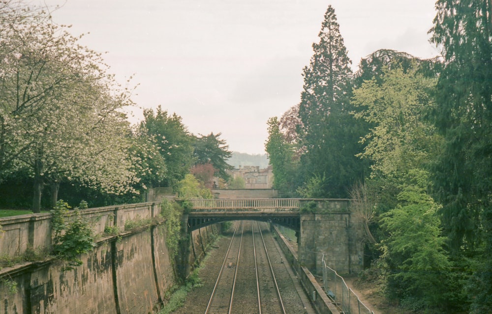 a train track with a bridge in the background