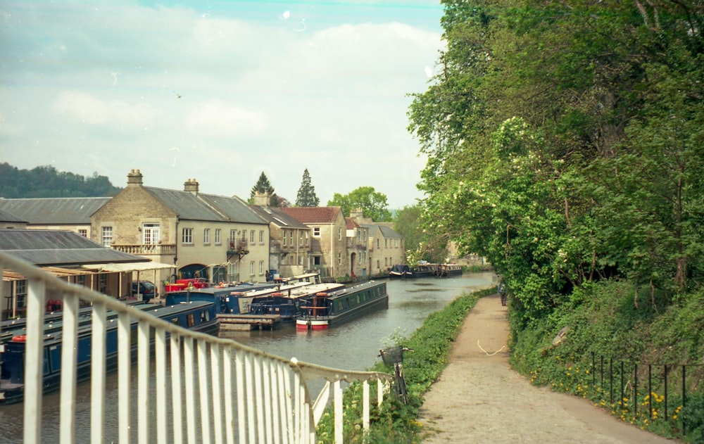 a narrow waterway with boats parked along the side of it