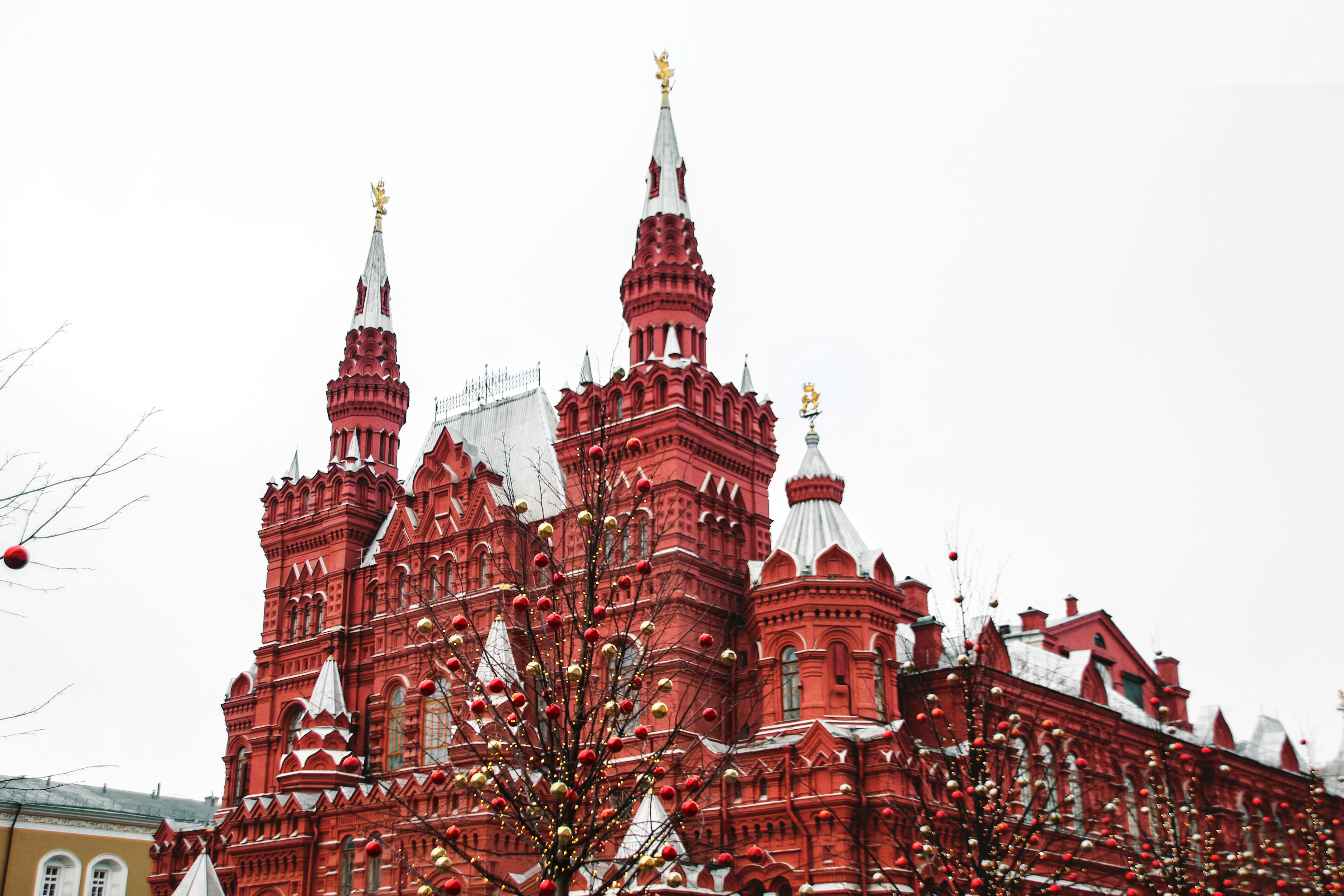 a large red building with a christmas tree in front of it