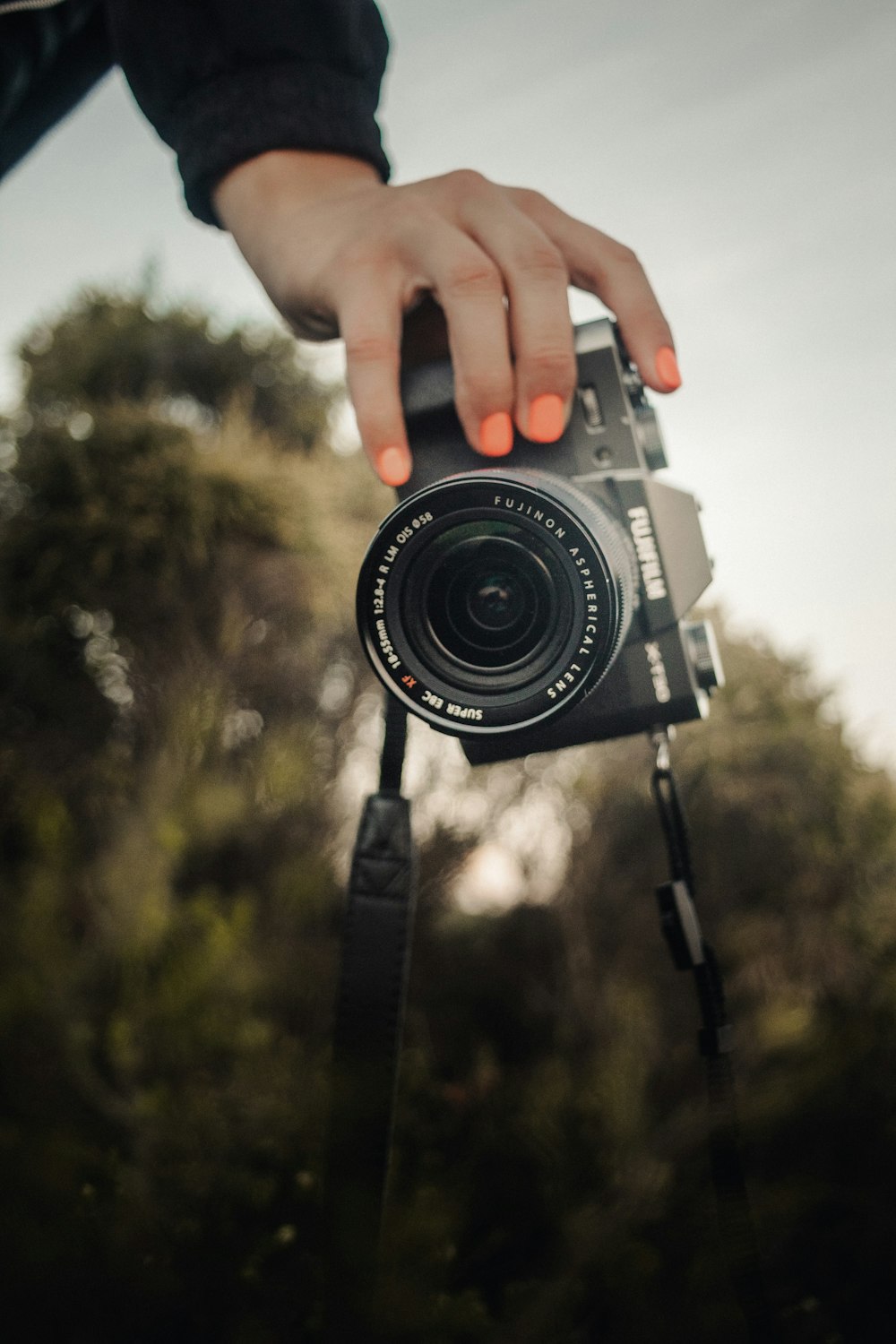 a person holding a camera in their hand