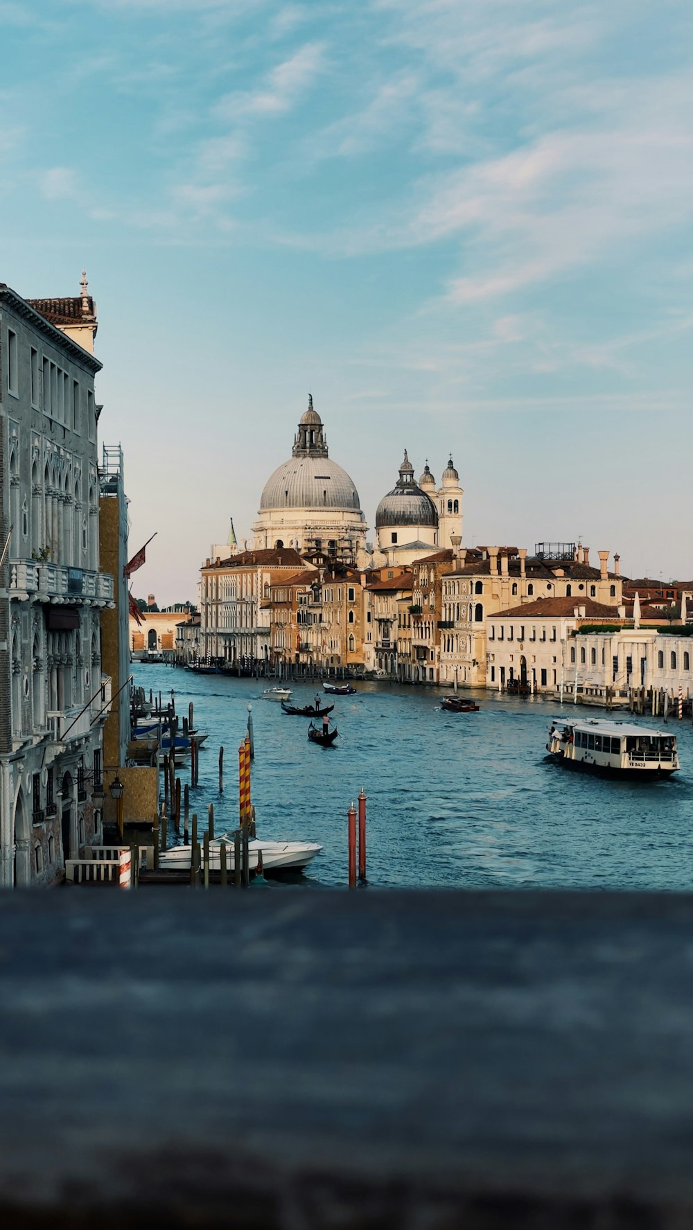 a view of a waterway with boats and buildings in the background