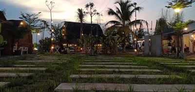 A serene view of the resort's lush garden with cozy seating areas under soft evening lights.