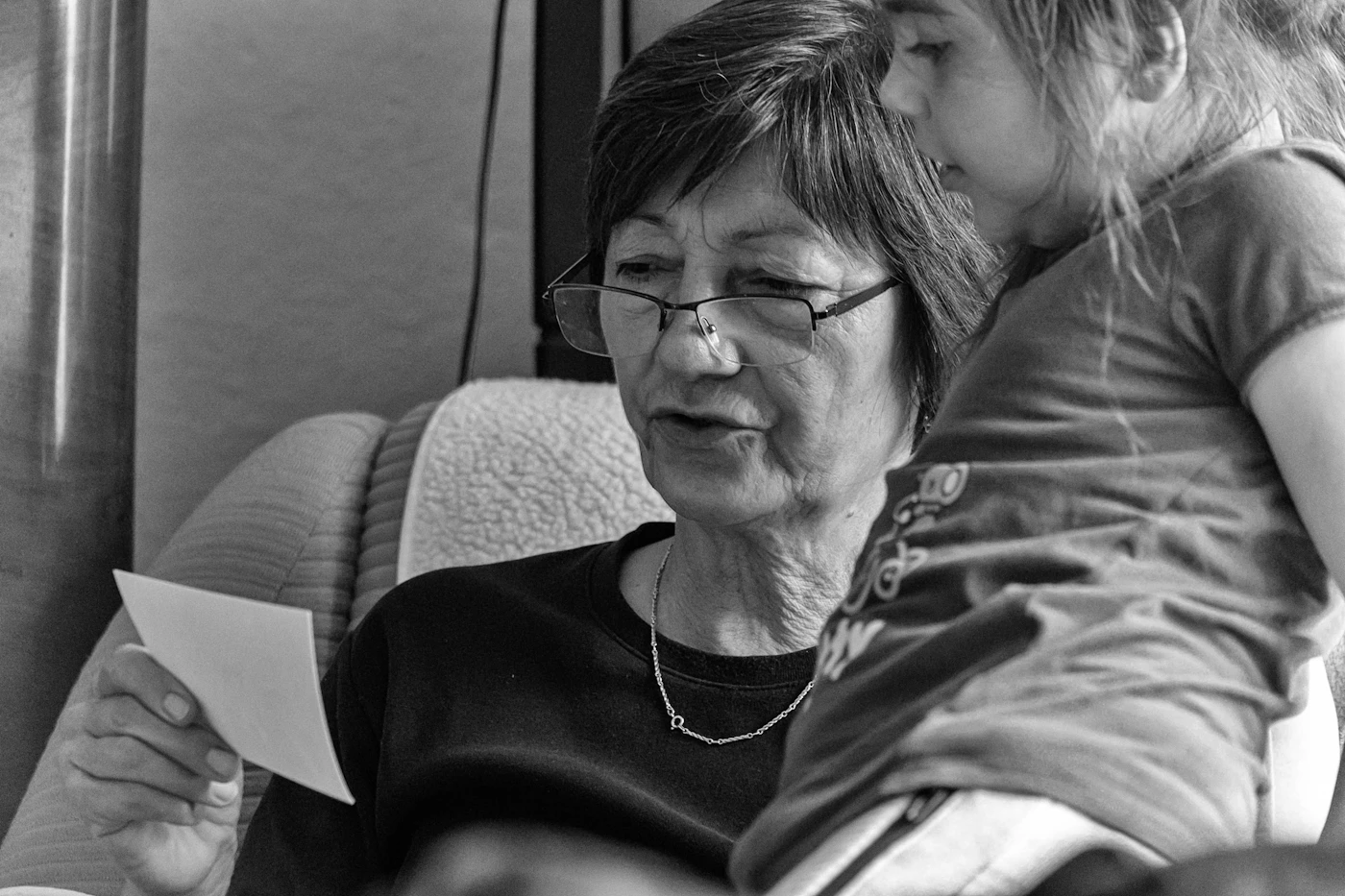 An older woman in glasses smiling