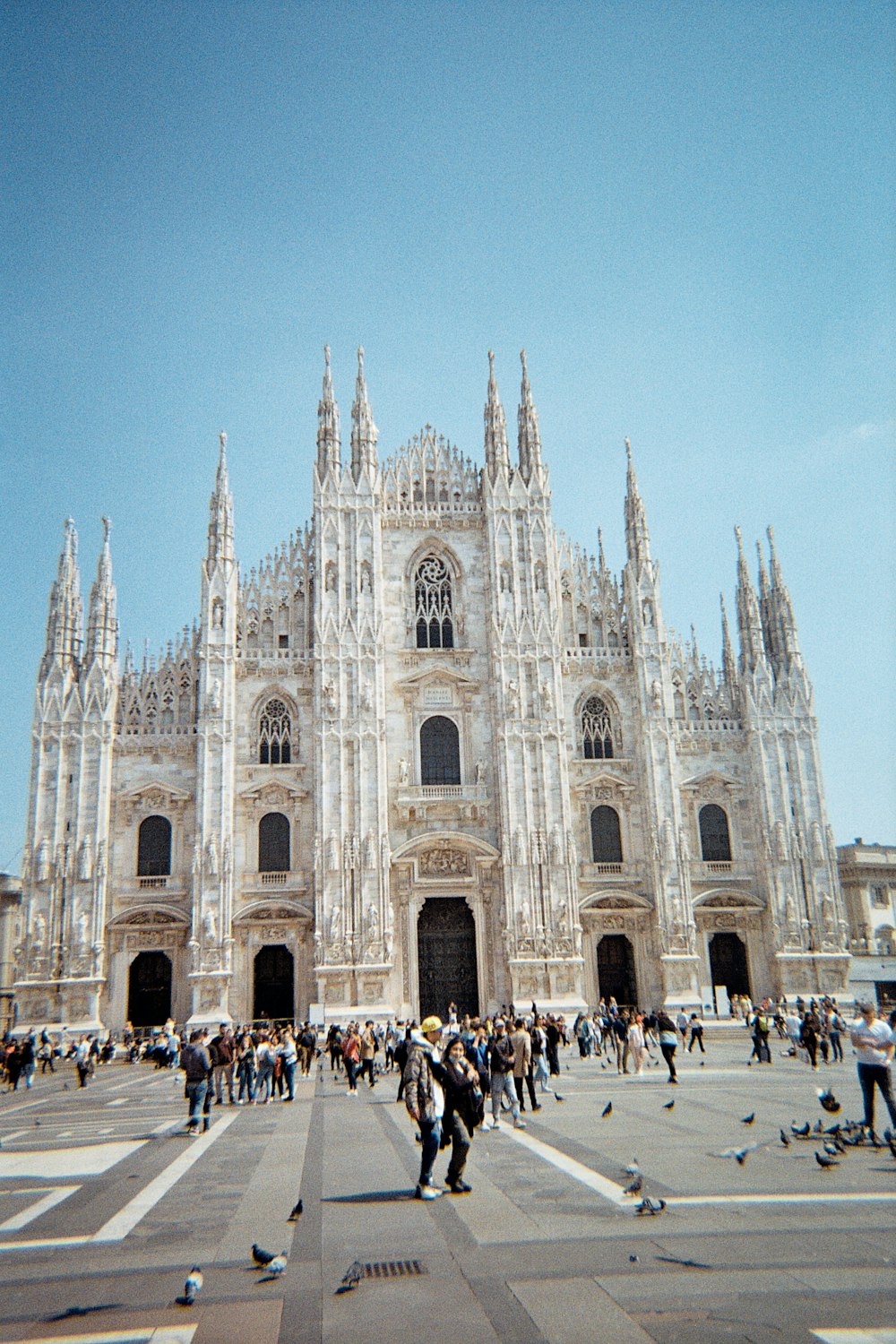 a group of people standing in front of a large building