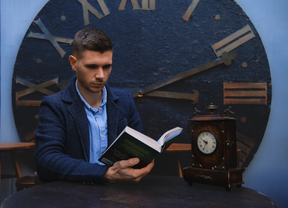 a man sitting in front of a clock