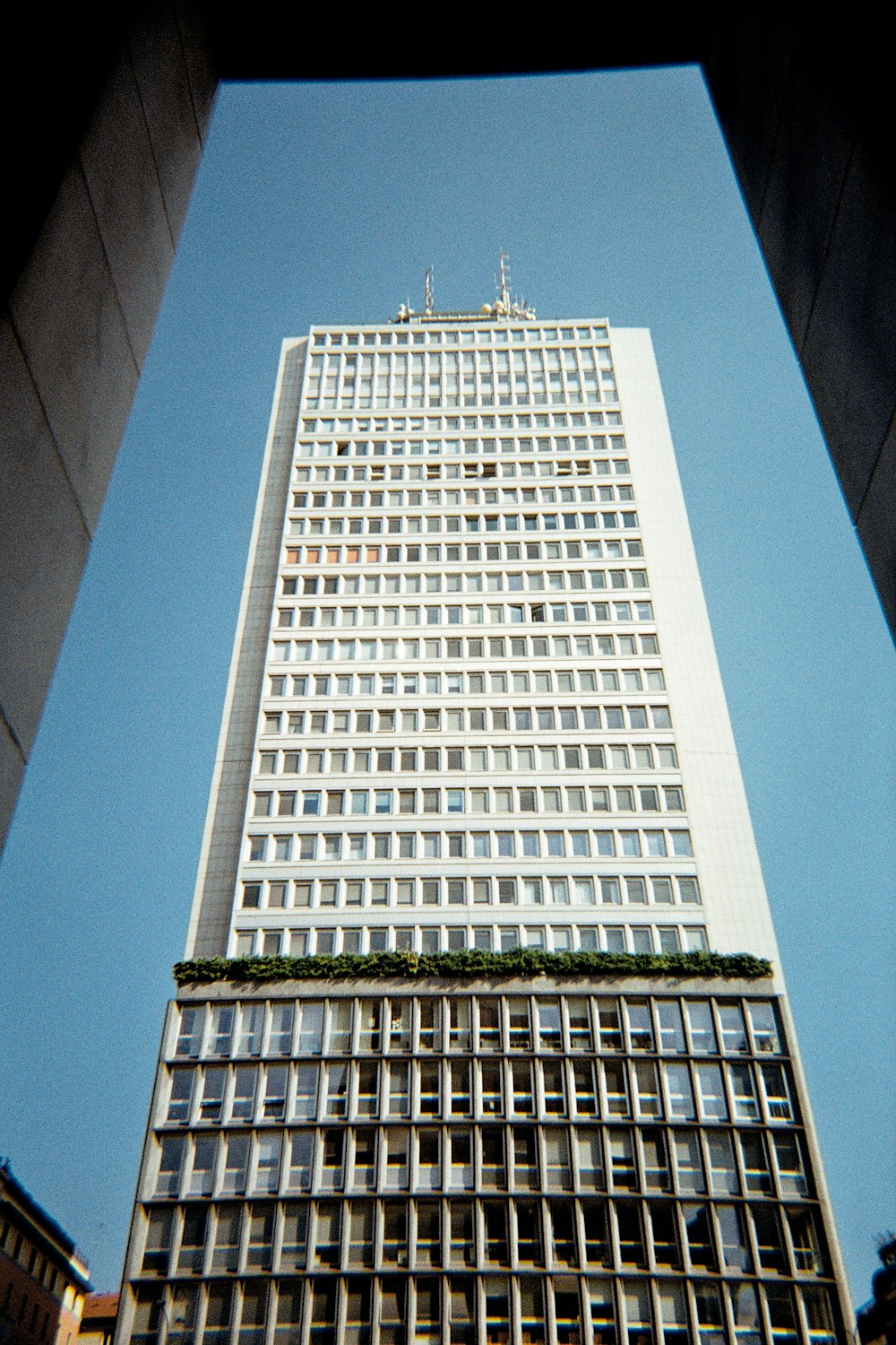 a tall white building with lots of windows