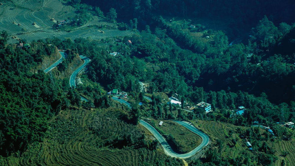 an aerial view of a winding road in the mountains