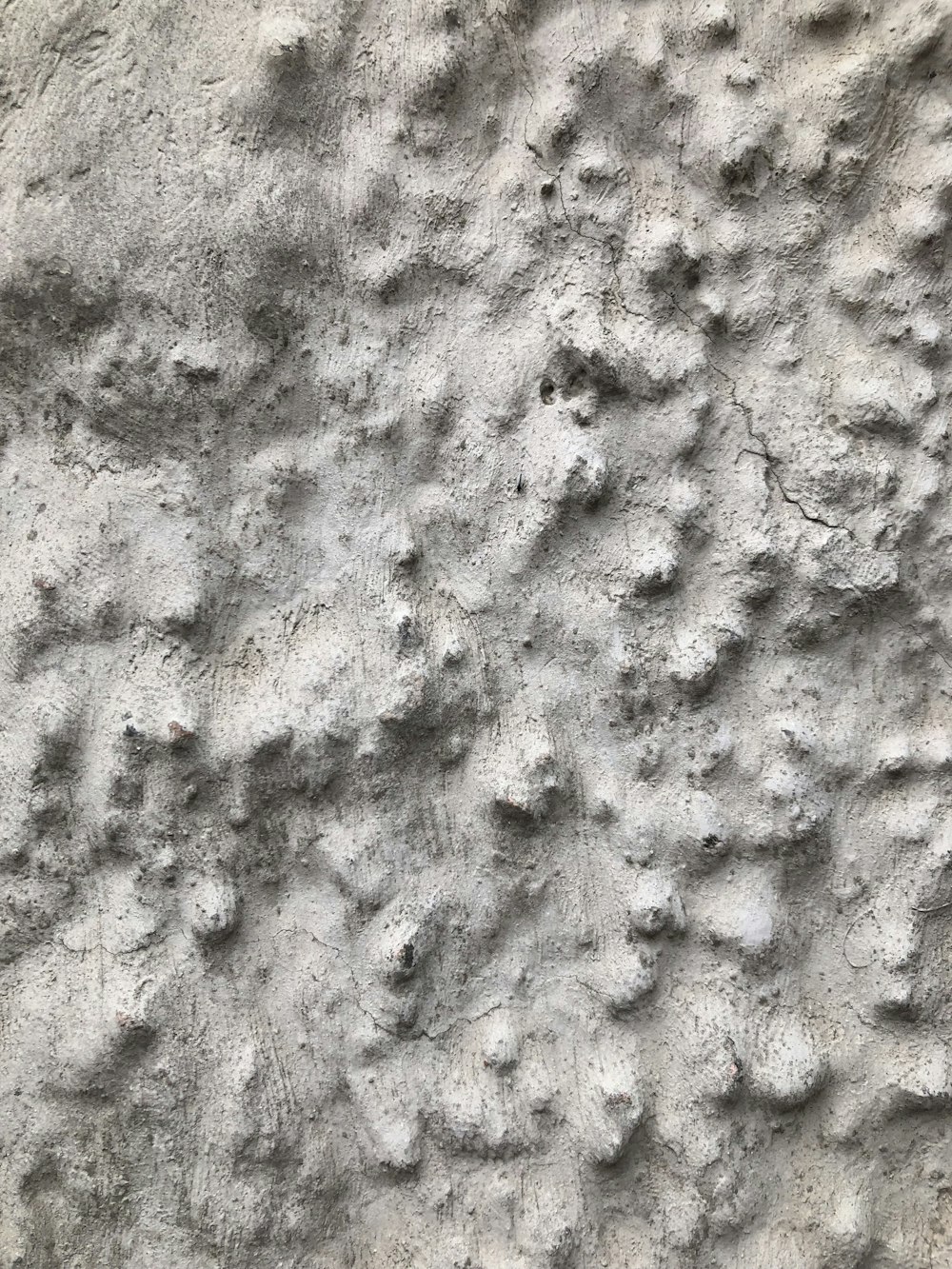 a close up of a rock wall with small holes in it