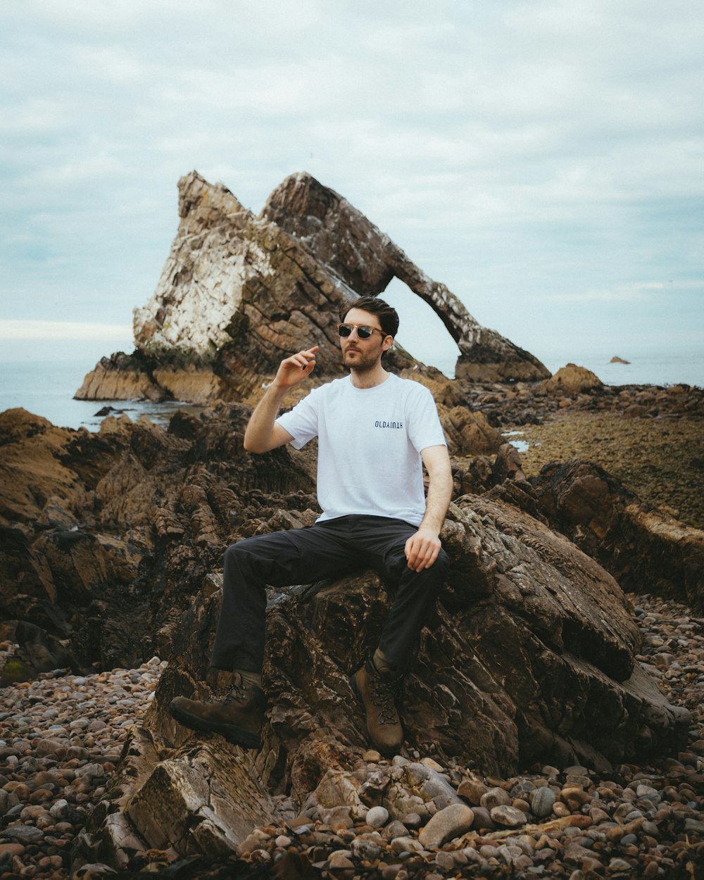 a man sitting on top of a pile of rocks