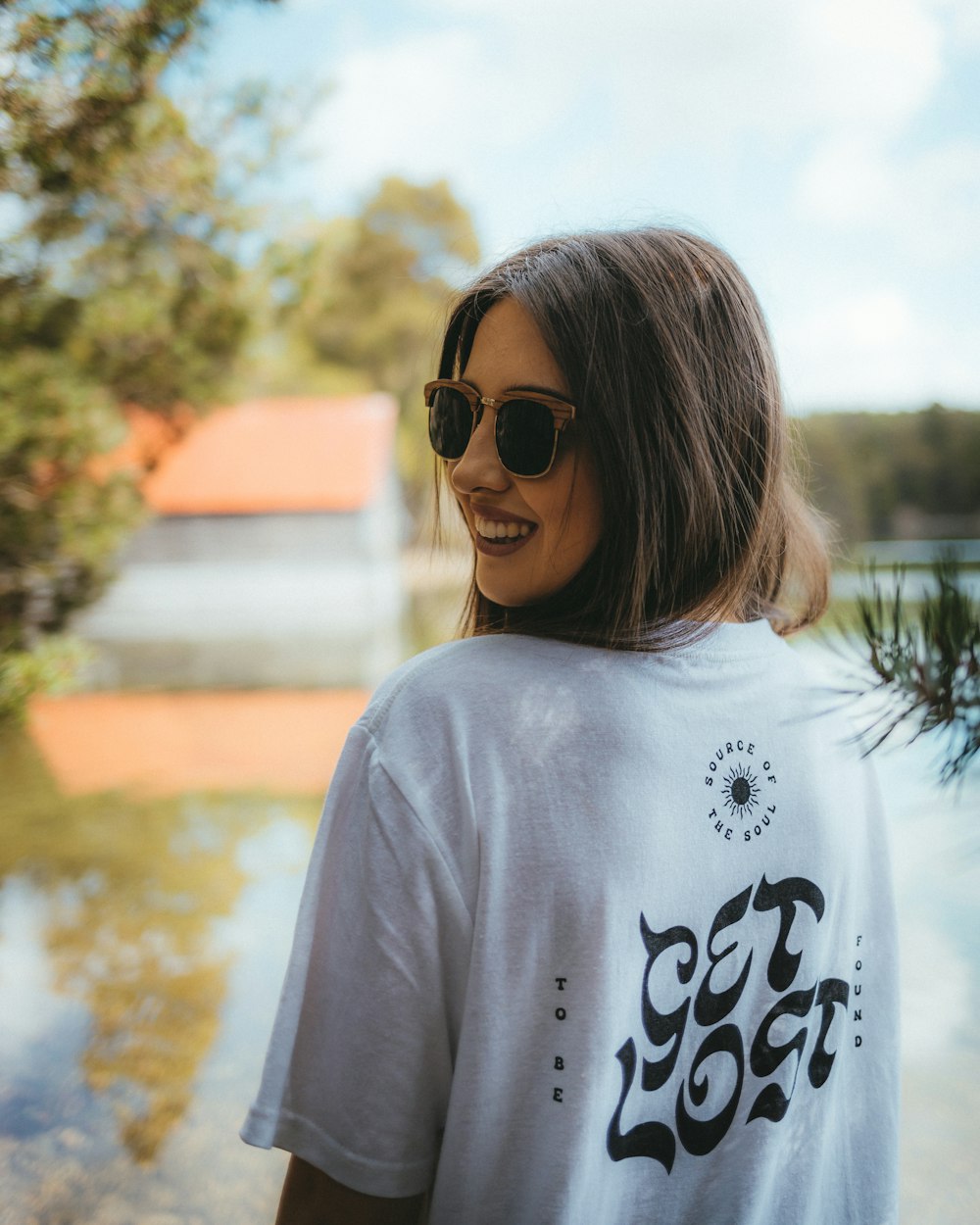 a woman wearing a white shirt and sunglasses