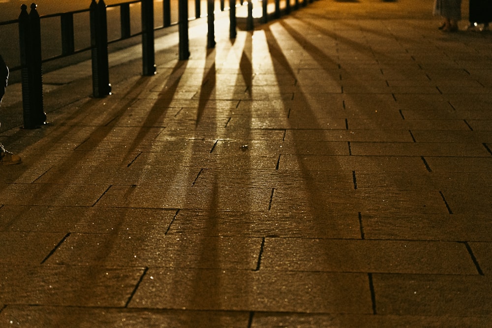 a person walking down a sidewalk at night