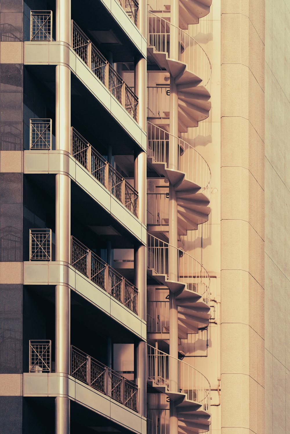 a tall building with balconies and a clock