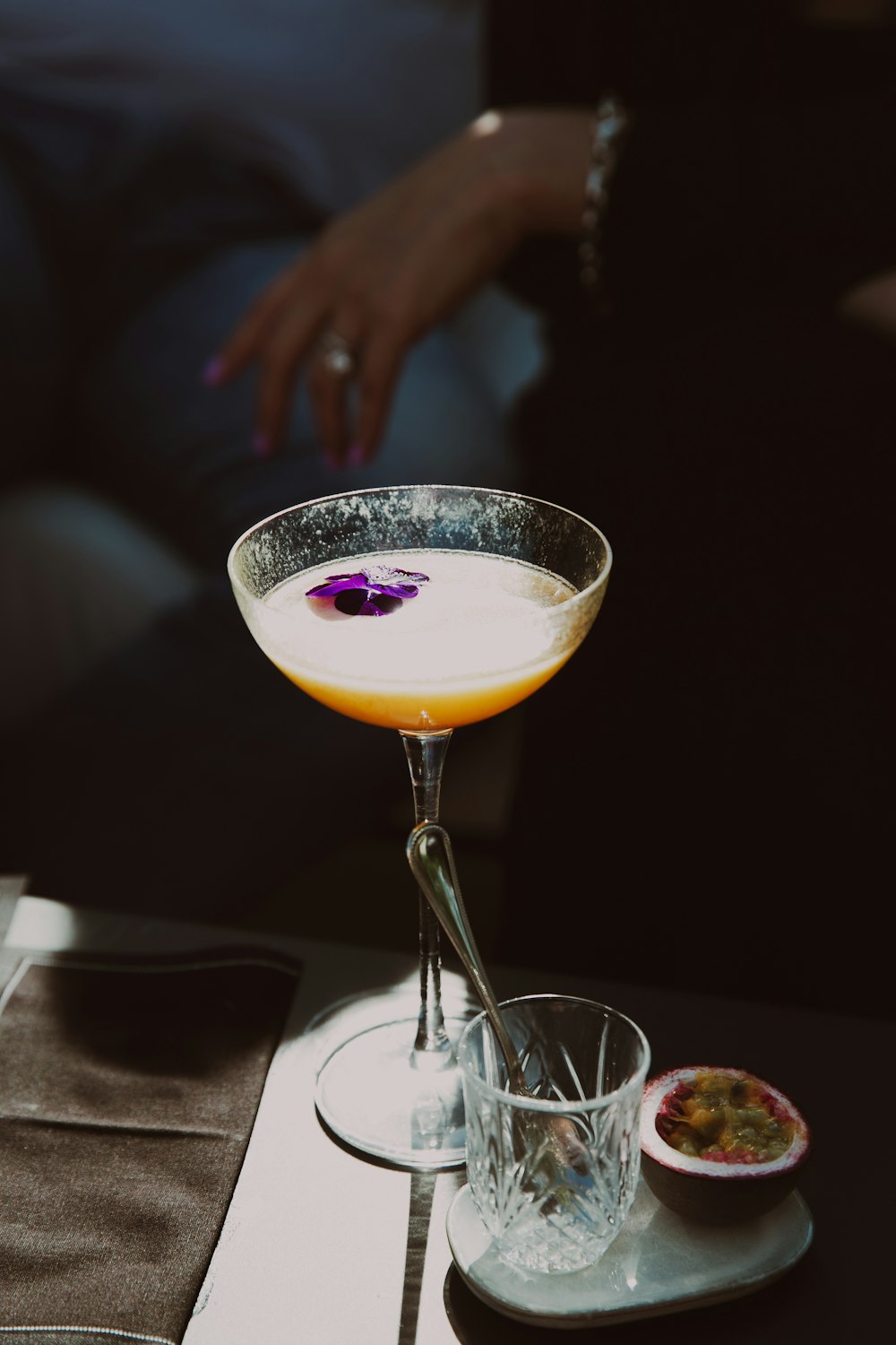 a glass filled with a liquid sitting on top of a table