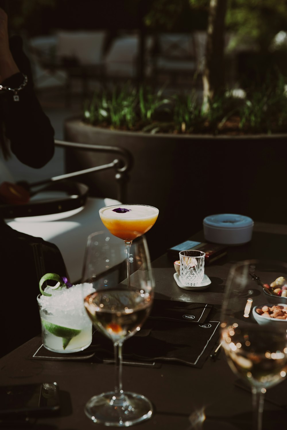 a table topped with glasses of different types of drinks