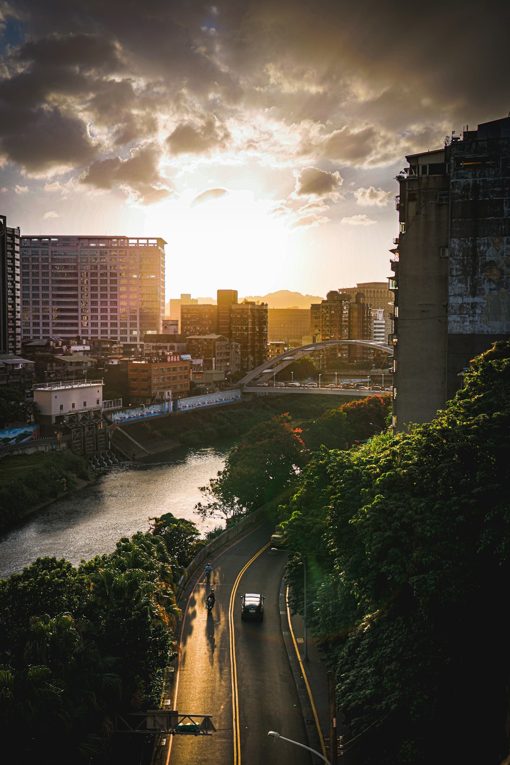 a car driving down a street next to a river