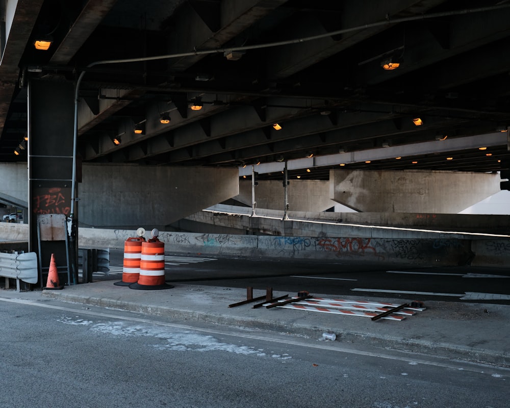 an empty parking garage with orange traffic cones