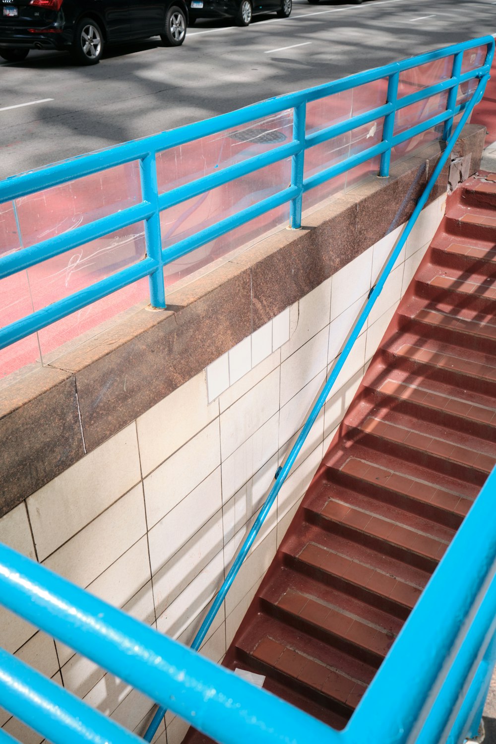 a set of stairs leading up to a parking lot