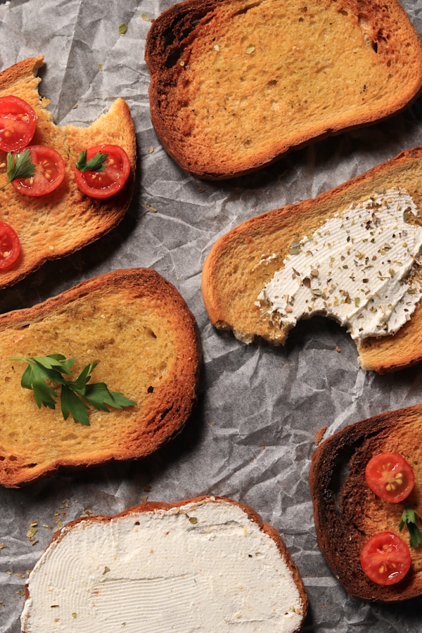Slices of bread with cream cheese and tomatoes on them