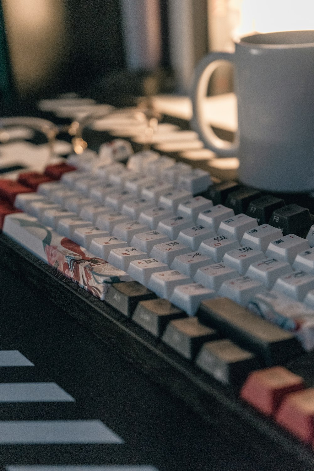 a coffee cup sitting on top of a computer keyboard