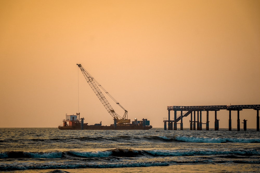 a large crane is in the middle of a body of water