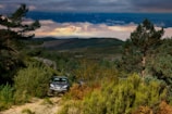 4x4 vehicle climbing rugged off-road paths with panoramic mountain views