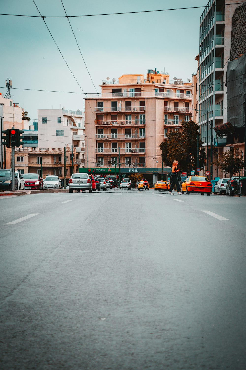 a city street filled with lots of traffic next to tall buildings