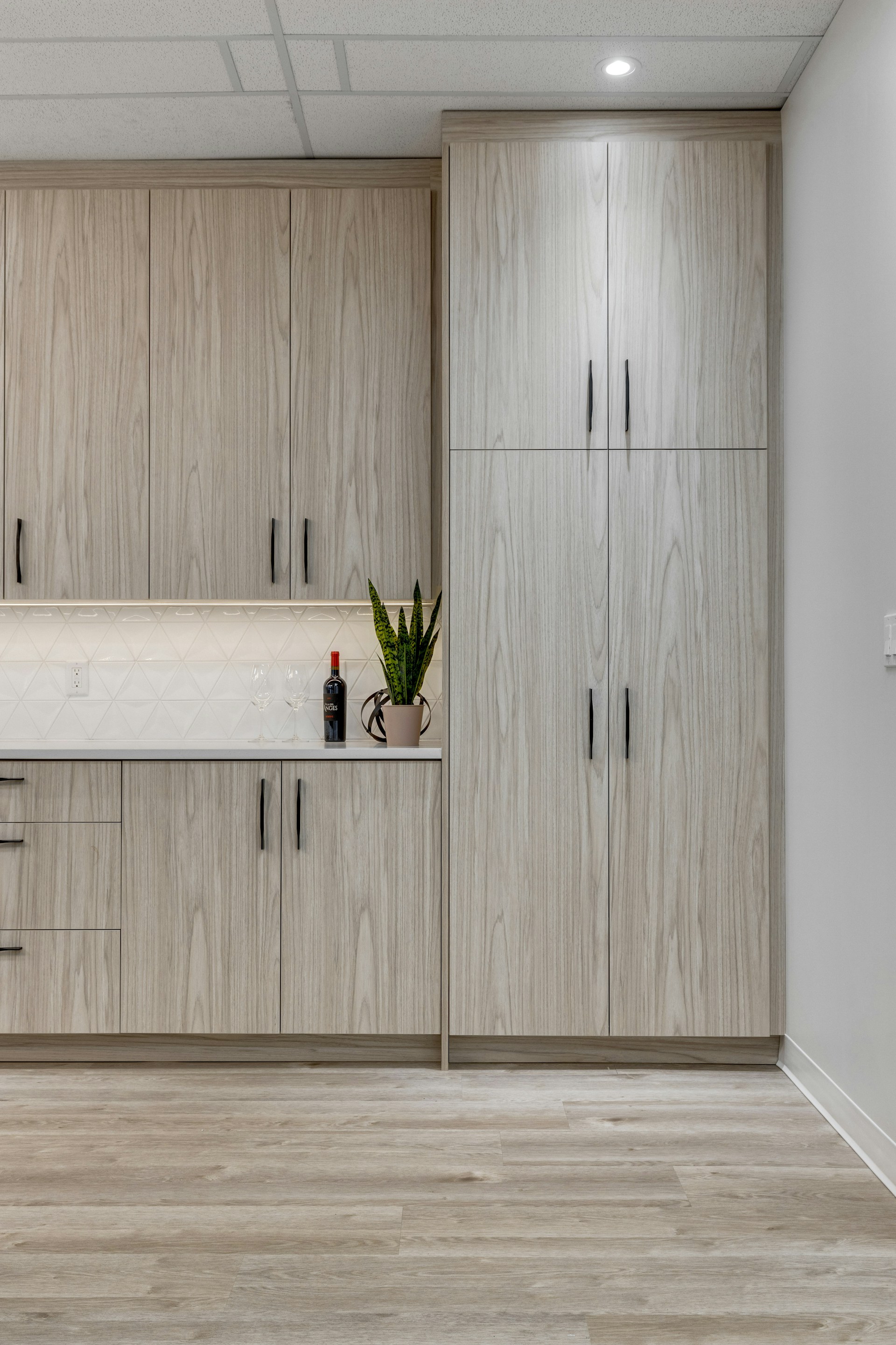 a kitchen with wooden cabinets and white counter tops