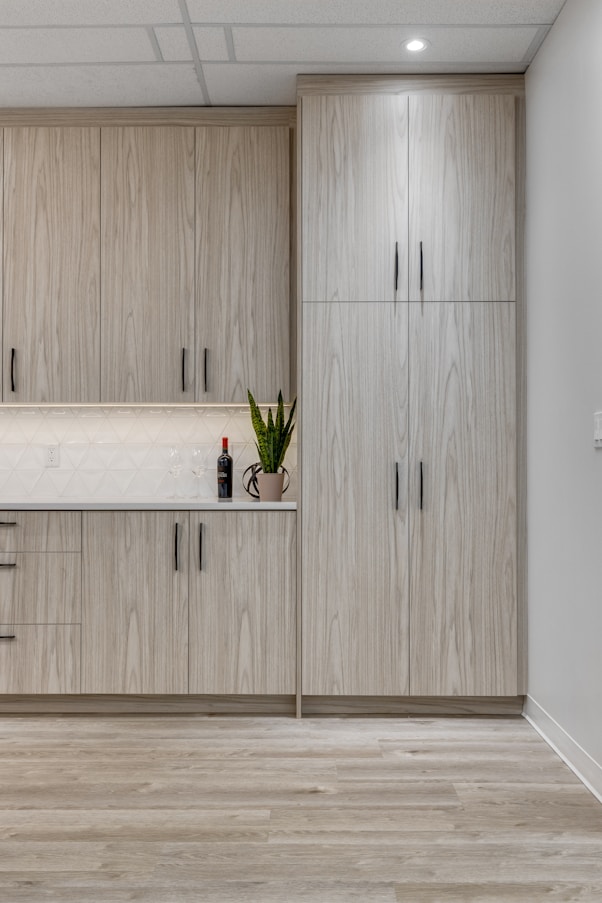 a kitchen with wooden cabinets and white counter tops