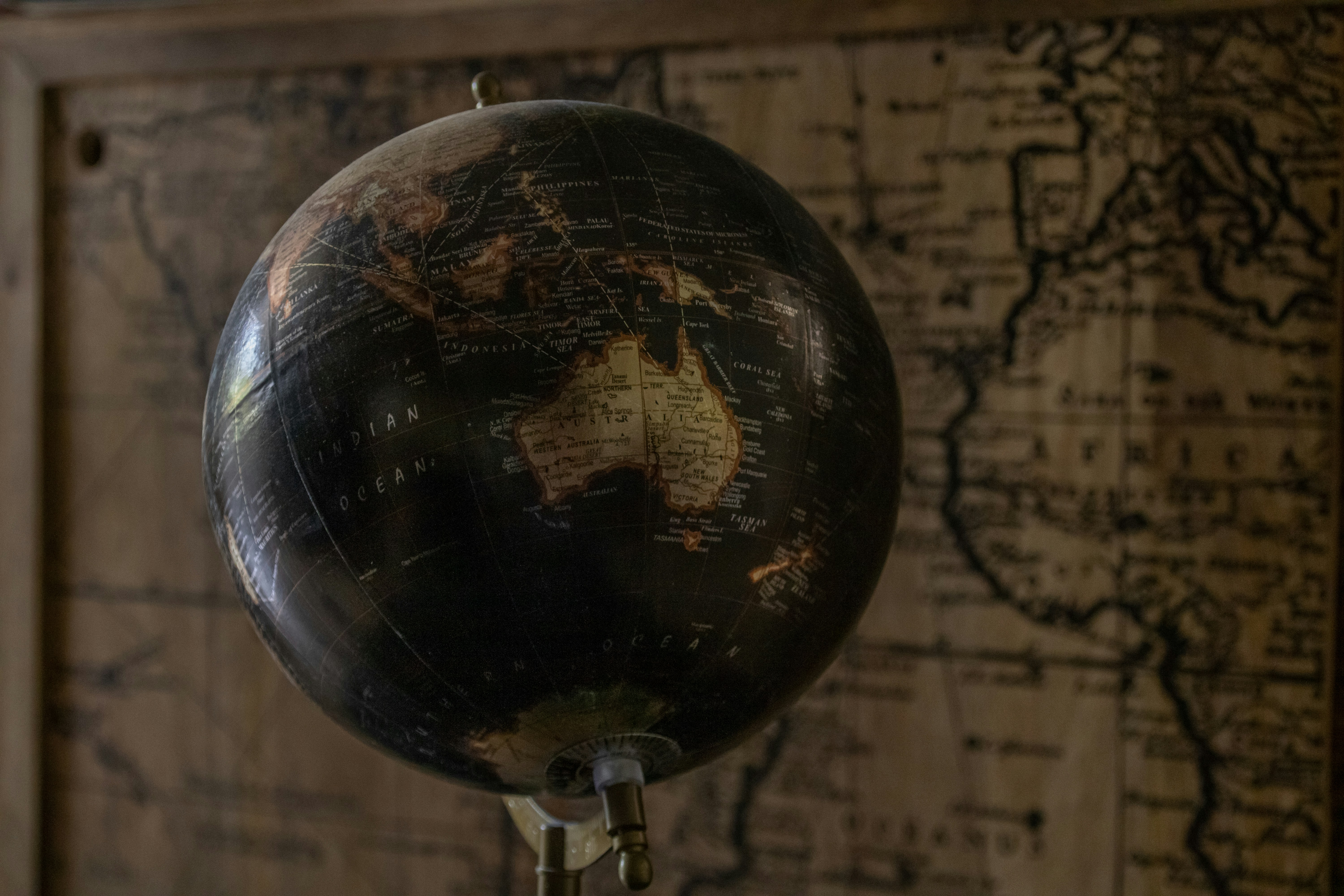 A black and gold globe on a stand in front of a map photo – Free Black  Image on Unsplash, image size:3000x2000