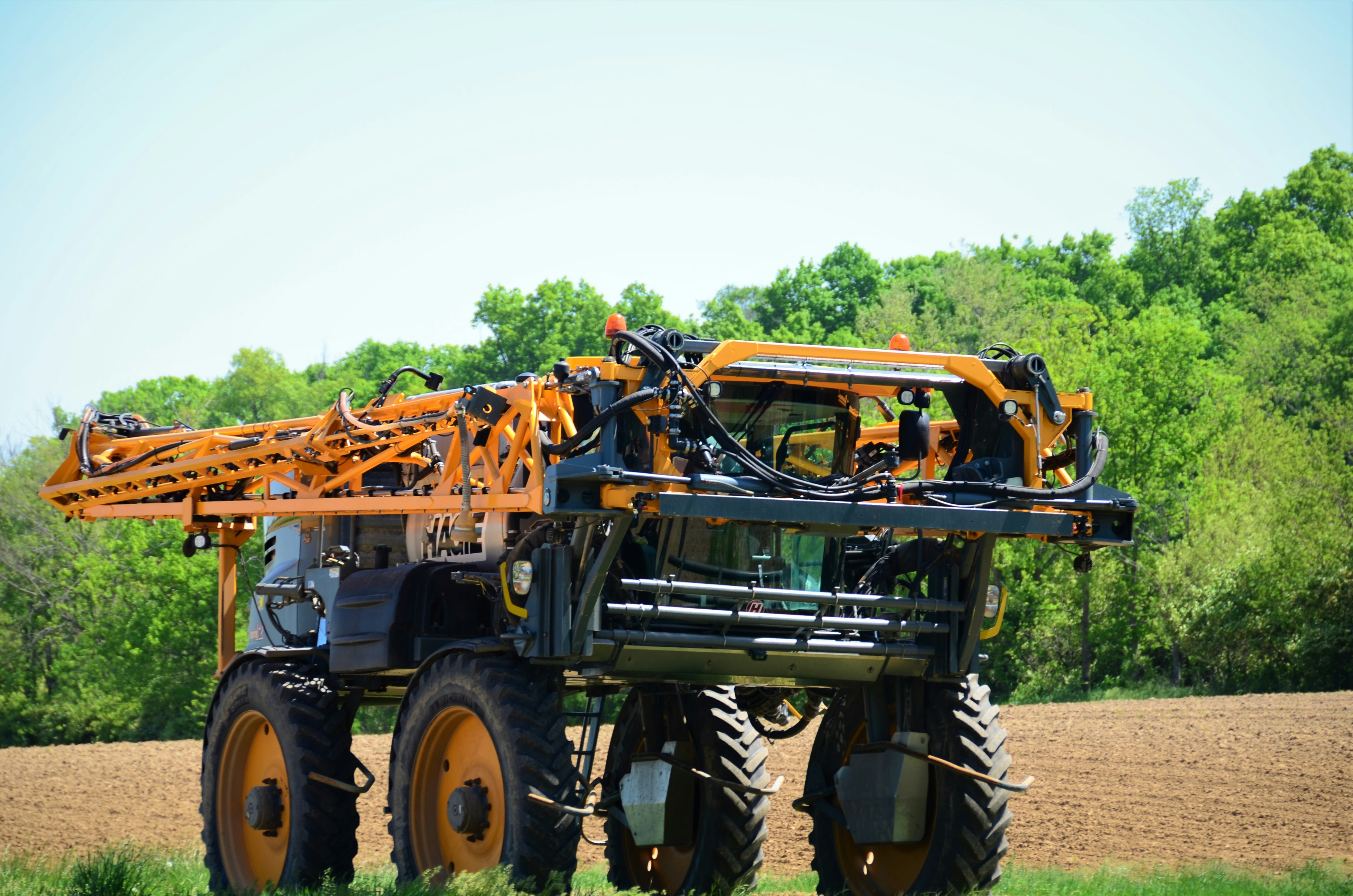 a tractor with a crane attached to it in a field