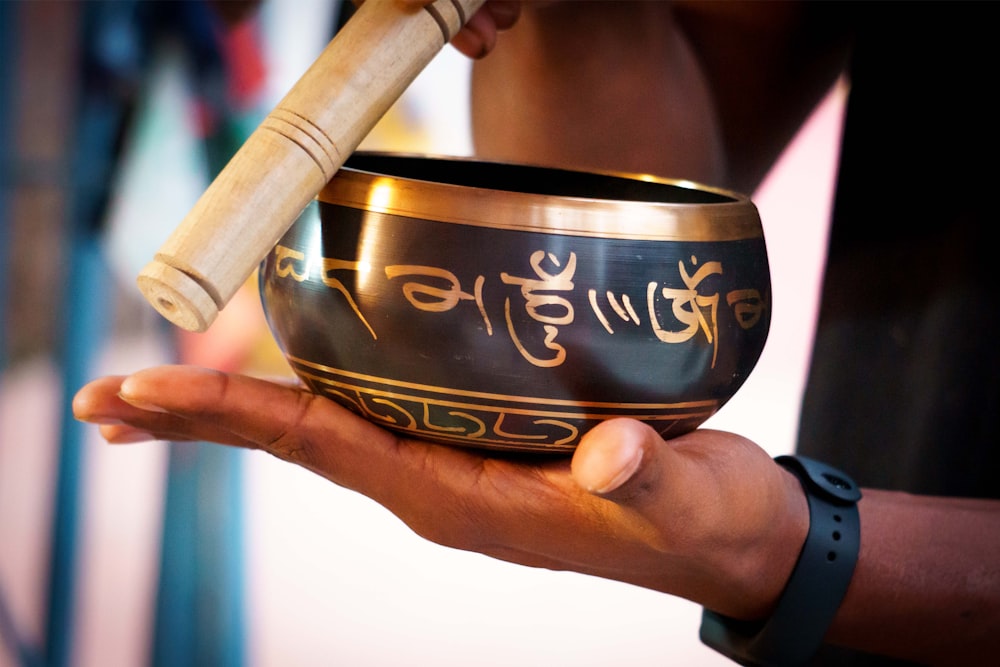 a person holding a singing bowl in their hand